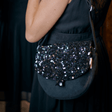 Flap of small shoulder bag purple black sequin