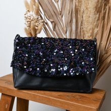 Flap of shoulder bag purple black sequin