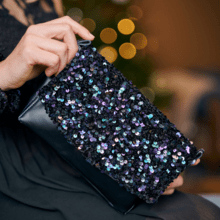 Flap of shoulder bag purple black sequin